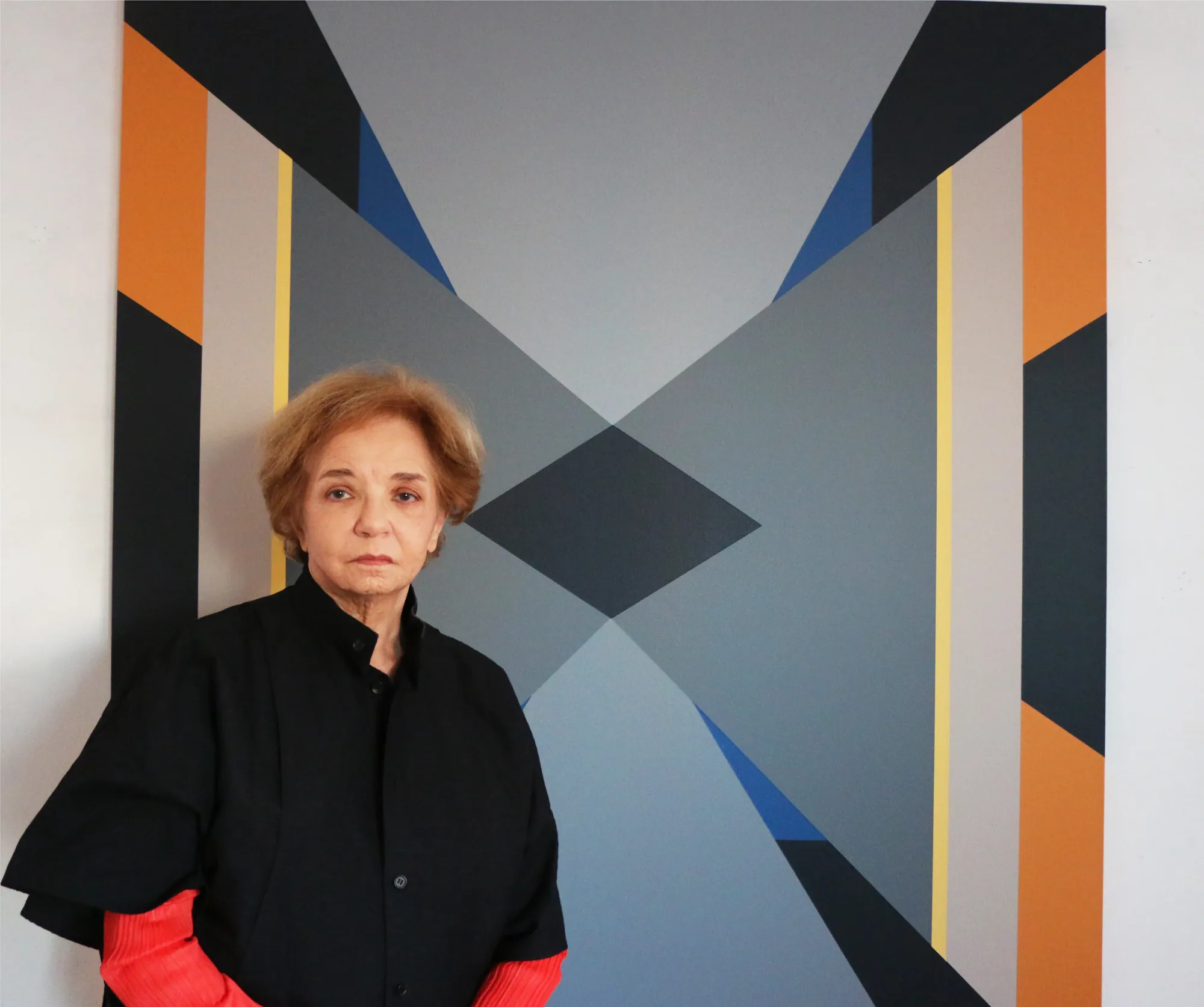Fanny Sanín in front of one of her geometric paintings
