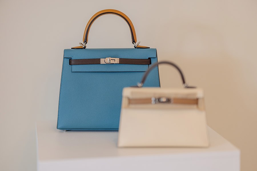 Hermès Kelly handbags presented on plinths at the Front Row pop-up